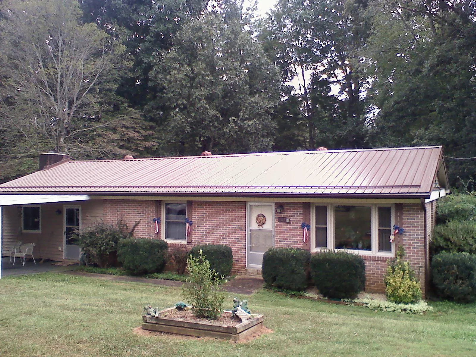Bronze metal roof on a brick ranch home with a carport in Santa Clarita