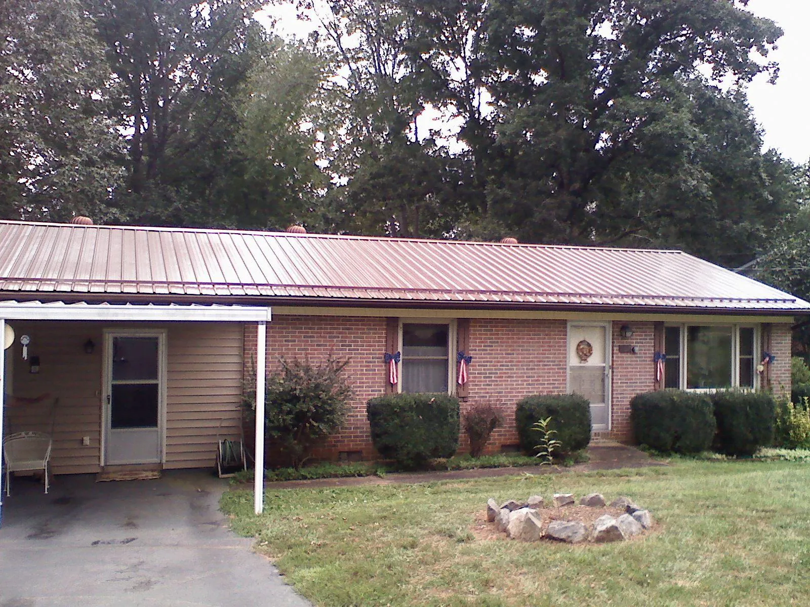 Bronze metal roof and carport on a brick ranch home — Roof Repair work by our crew in Santa Clarita